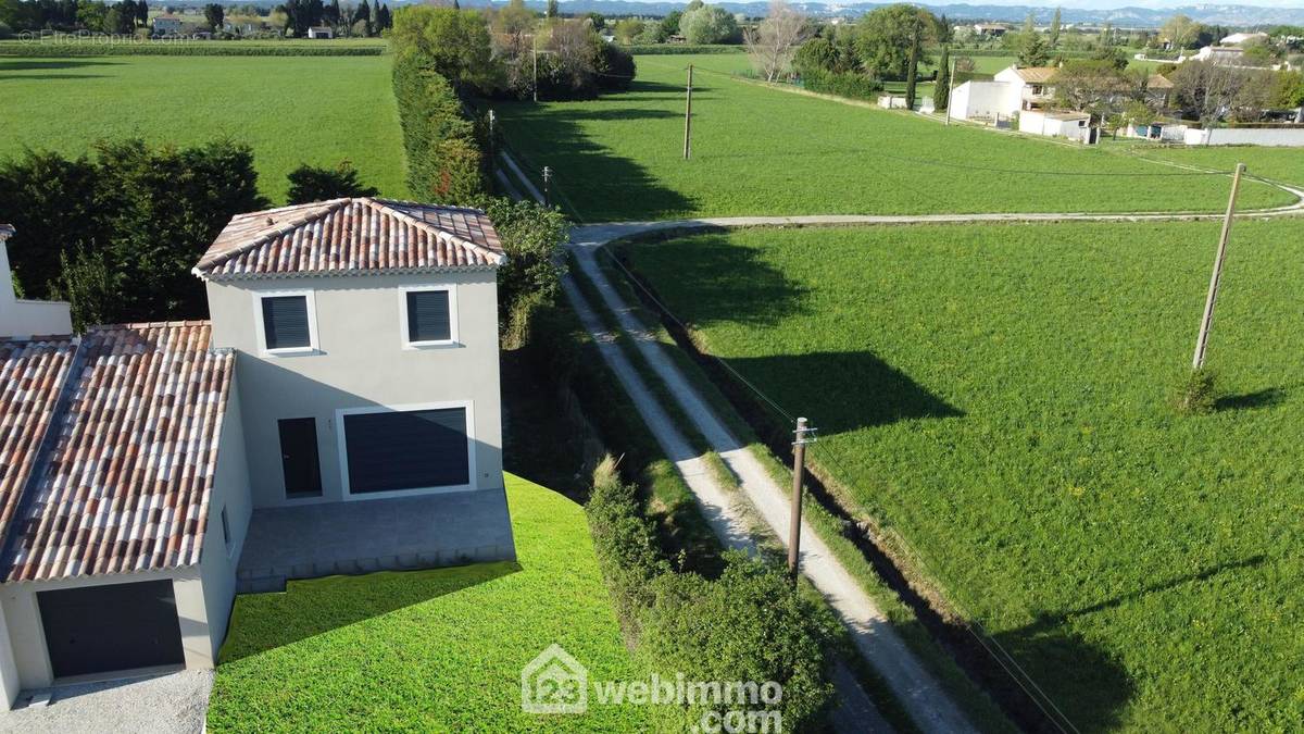 Une vue aérienne de la villa, son toit 4 pentes et le garage - Maison à ARLES